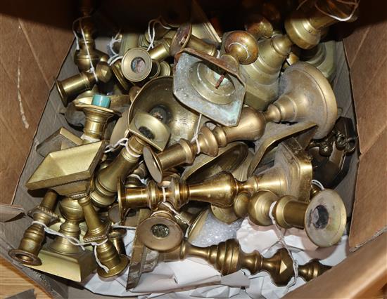 Approximately seventeen pairs of Victorian and later brass candlesticks and a wager cup